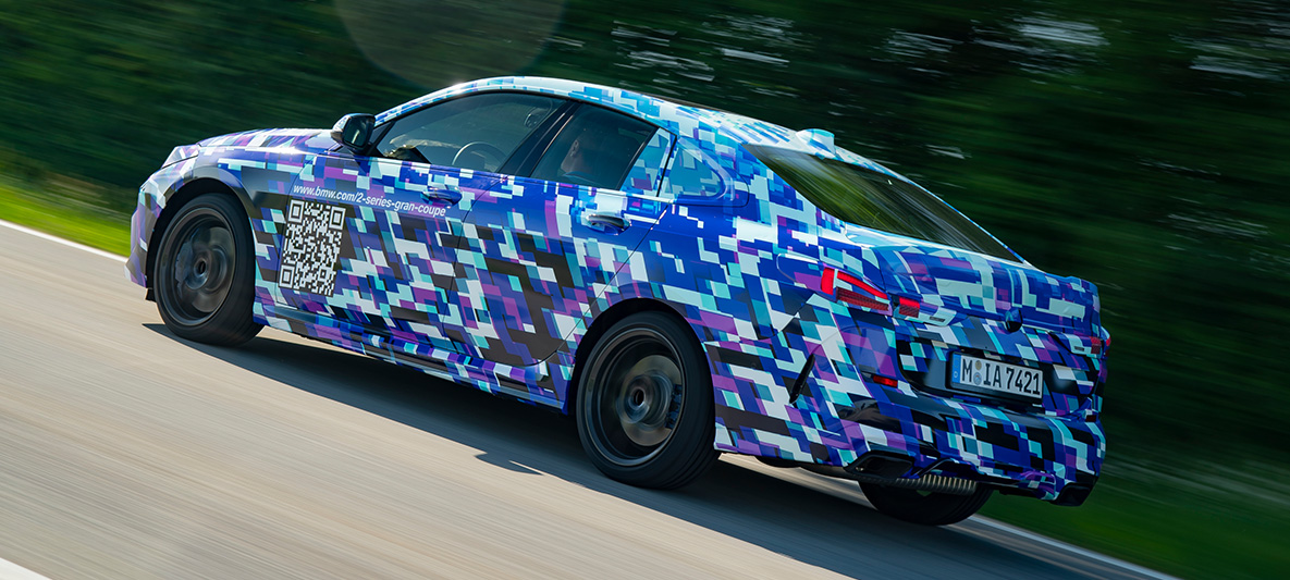 Driving dynamics BMW 2 Series Gran Coupé BMW 2 Series Gran Coupé F44 BMW M235i xDrive sporty driving exterior design three-quarter side view disguised prototype car