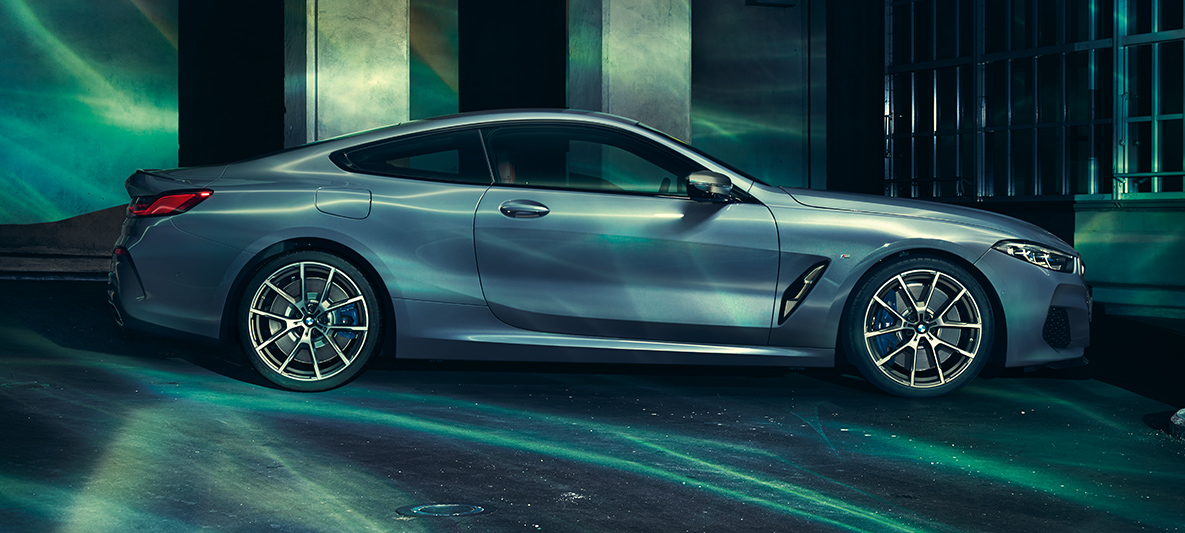 The BMW 8 Series, side view A still shot of the BMW 8 Series Coupé from the side in an urban setting.