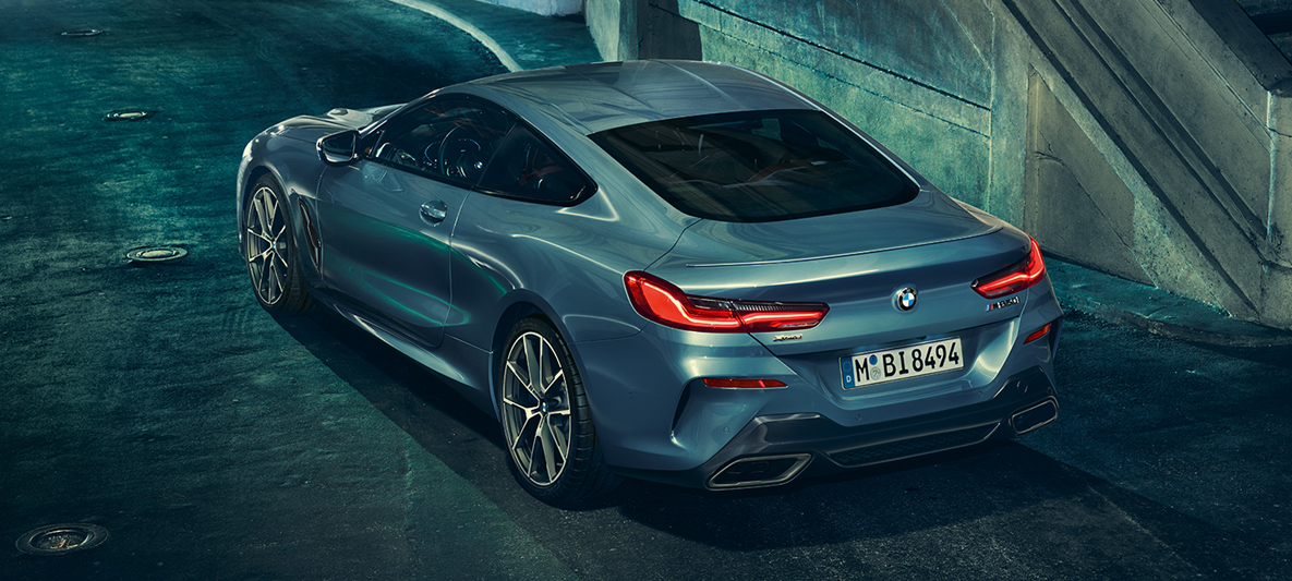BMW 8 Series Coupé, three-quarter rear shot, from top Three-quarter rear shot of the BMW 8 Series Coupé at night from top view.