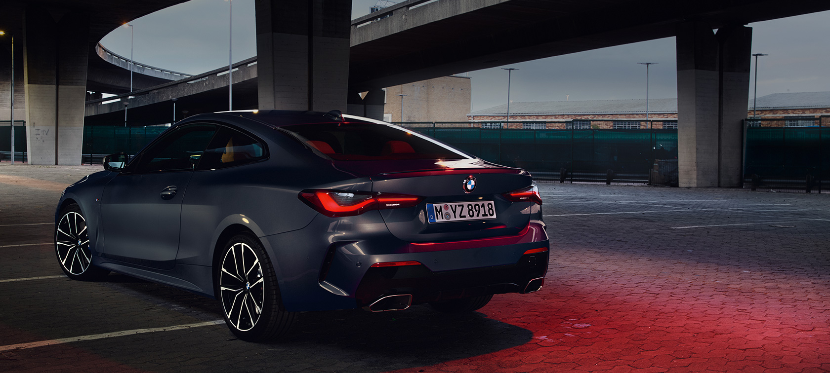 BMW M440i xDrive Coupe G22 (2020), вид сзади с поворотом в три четверти BMW M440i xDrive Coupe G22 (2020), Серый Дравит металлик, вид сзади с поворотом в три четверти