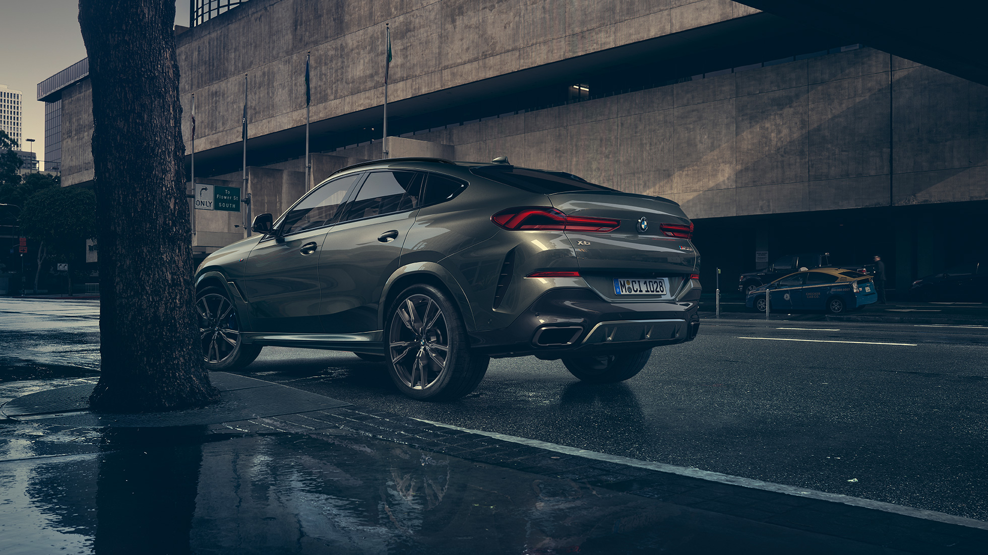 BMW X6 exterior. BMW X6 in three-quarter rear perspective in front of an urban setting.